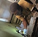 Construction Mechanic 2nd Class Tyler Miller, conducts equipment repairs .