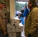 Rich Giero helps Loaves &amp; Fishes staff weigh the food at the facility during drop off.