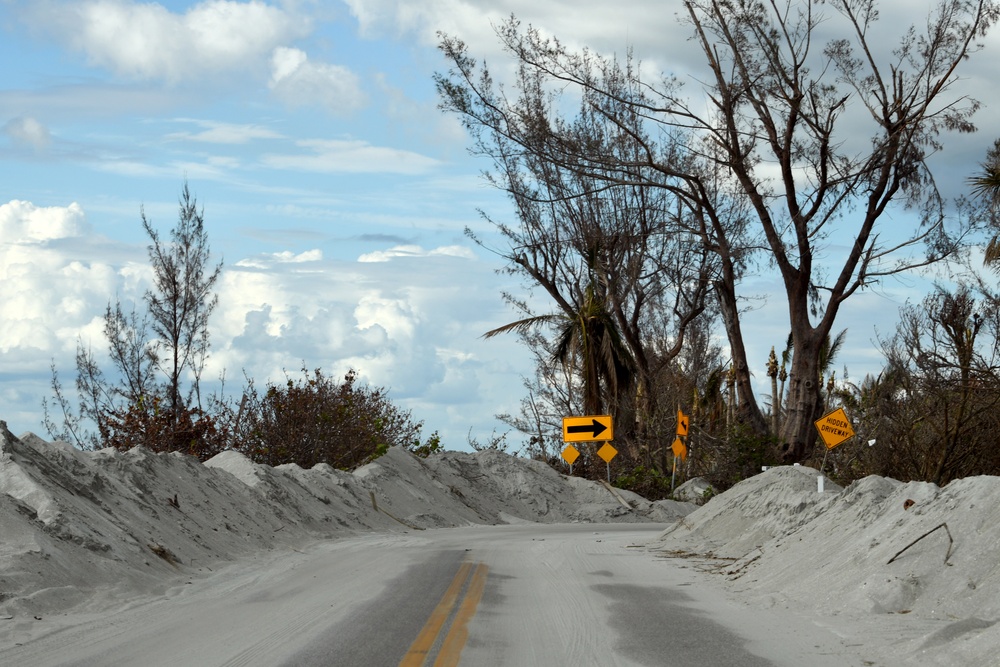 Sand Lines the Streets in Neighborhoods Impacted By Hurricane Ian