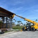 Seabees with Naval Mobile Construction Battalion 4, install the soffit on the Richardson Multipurpose Facility.