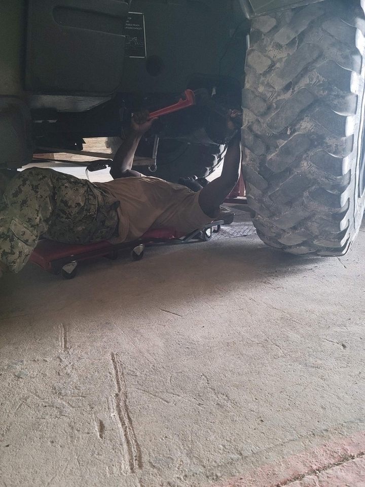 Construction Mechanic 2nd Class Tyler Miller, conducts maintenance on the 11k forklift.