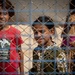 Young girls look to a US Civil Affairs team through the fence at al Hol camp