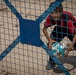 A boy smiles at a US Civil Affairs team through the fence at al Hol camp