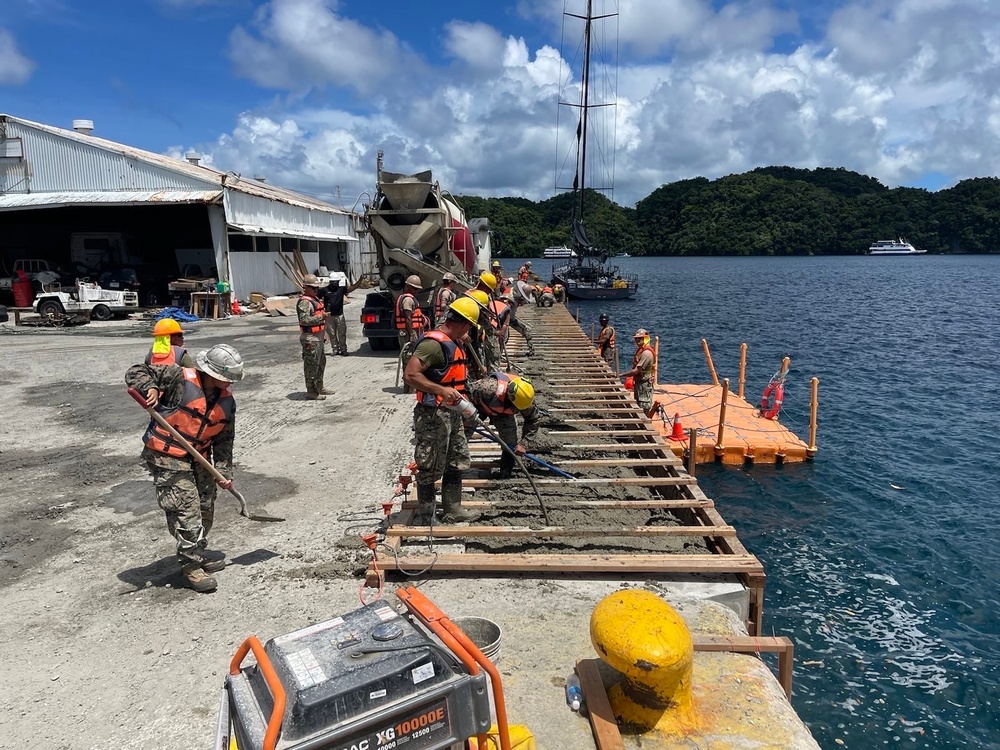 Seabees attached to Naval Mobile Construction Battalion 4, place concrete as part of the Malakal Harbor Improvements Project.