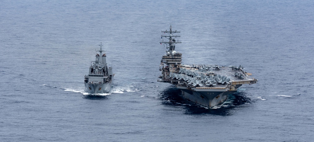 USS Ronald Reagan (CVN 76) conducts replenishment at sea with HMAS Stalwart (A304)