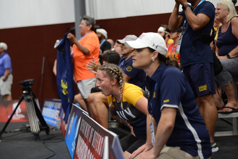 HM2 Sarah Rockhold cheering for Team Navy during indoor rowing competition at the 2022 Warrior Games
