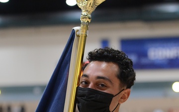 PR2 Zachariah Refahi El Masry holds the Navy flag during a wheelchair basketball game