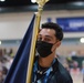 PR2 Zachariah Refahi El Masry holds the Navy flag during a wheelchair basketball game