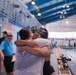 YN1 Sharmesha Creamer hugging MC Ren Hockenberry after her swim competition
