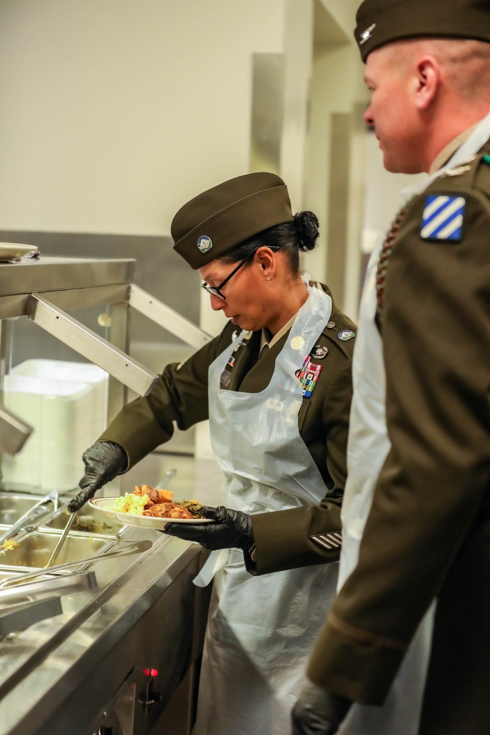 The 3rd Division Sustainment Brigade 3rd Infantry Division serves Soldiers a Thanksgiving holiday meal