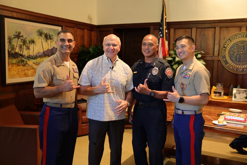 Cutting a cake in honor of the 247th birthday of the Marine Corps with the Mayor and city officials of Honolulu