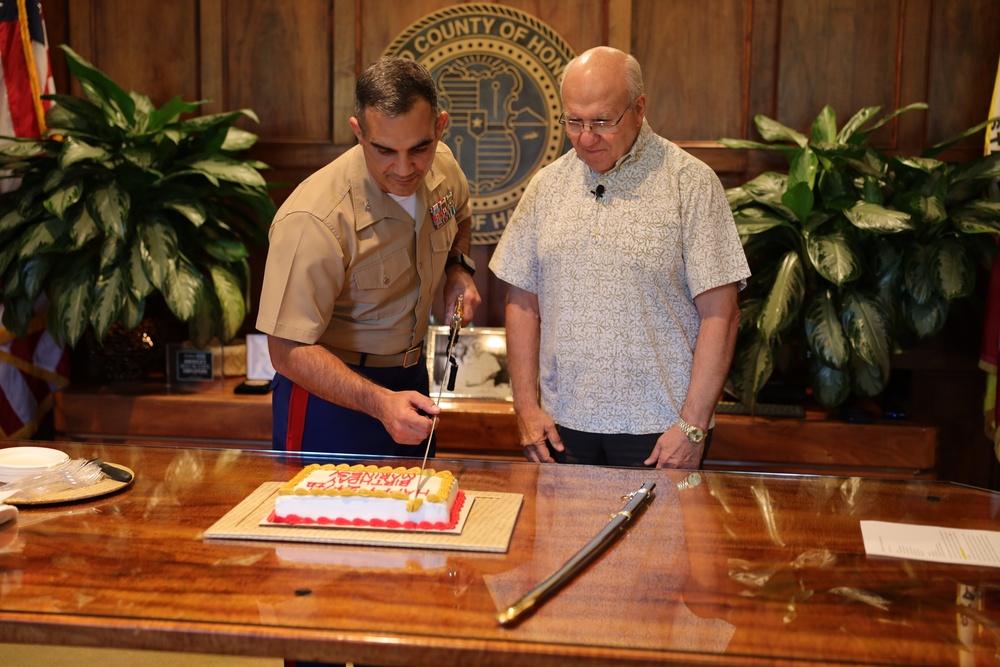 Cutting a cake in honor of the 247th birthday of the Marine Corps with the Mayor and city officials of Honolulu