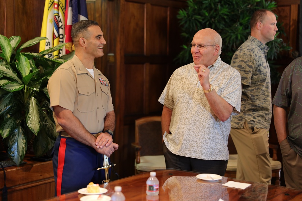 Cutting a cake in honor of the 247th birthday of the Marine Corps with the Mayor and city officials of Honolulu