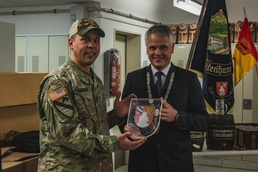 Soldiers with 41st FAB HHB BDE celebrate their new partnership with representatives from the community of Flossenbürg at Grafenwoehr, Germany