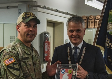 Soldiers with 41st FAB HHB BDE celebrate their new partnership with representatives from the community of Flossenbürg at Grafenwoehr, Germany