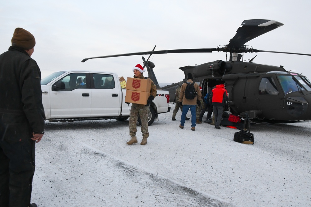 Alaska Air and Army National Guardsmen serve as elves and deliver Holiday packages to Minto