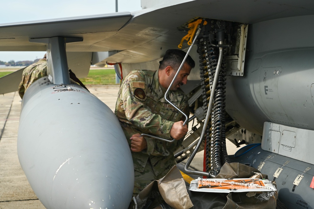 113th AMXS load ammunition into an F-16 aircraft
