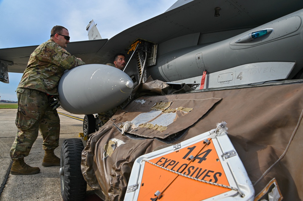 113th AMXS load ammunition into an F-16 aircraft
