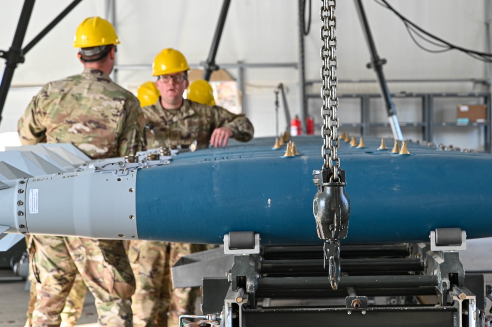 113th AMXS train by building GBU-38s