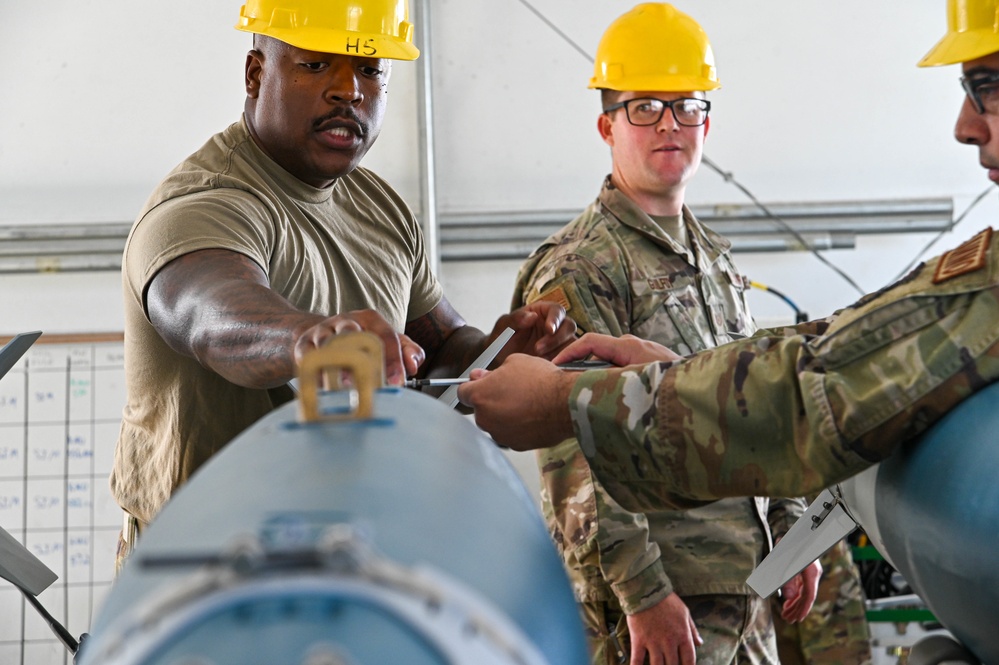113th AMXS train by building GBU-38s