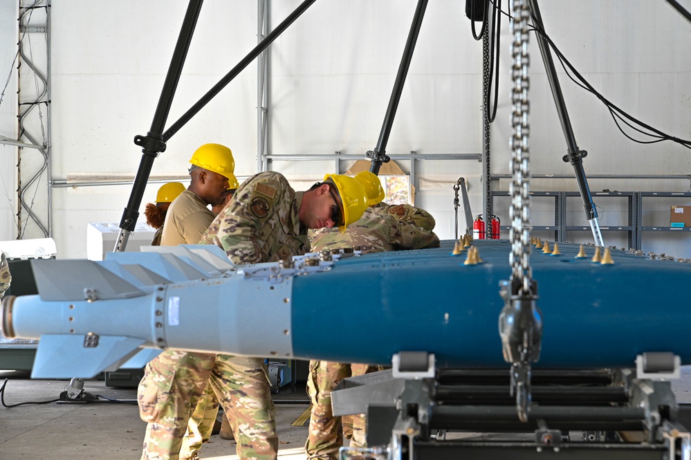 113th AMXS train by building GBU-38s