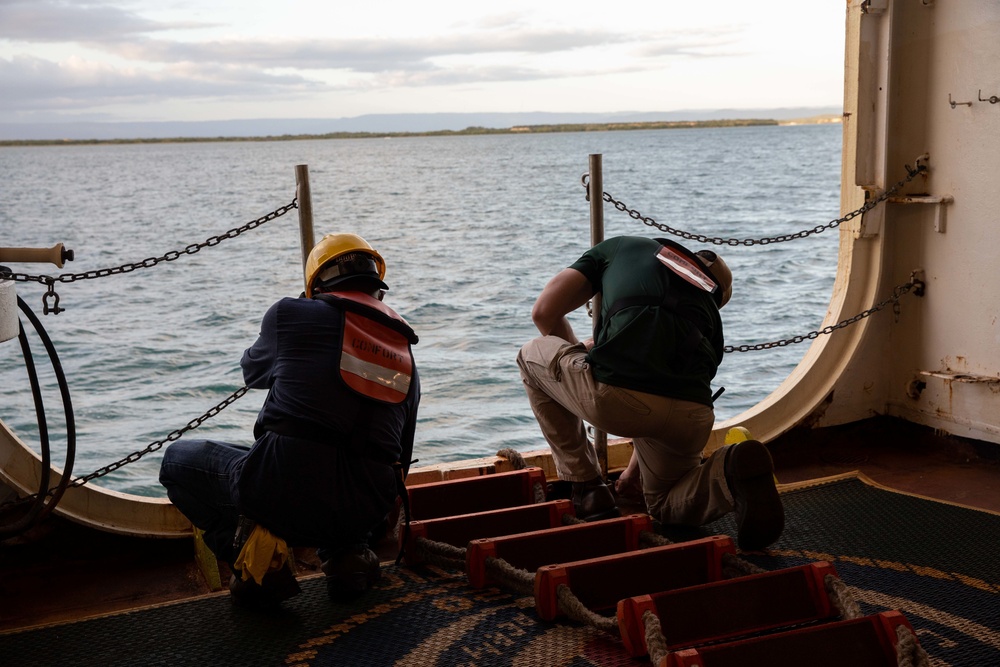 Civilian mariners assigned to the USNS Comfort, assist with a port departure during Continuing Promise 2022