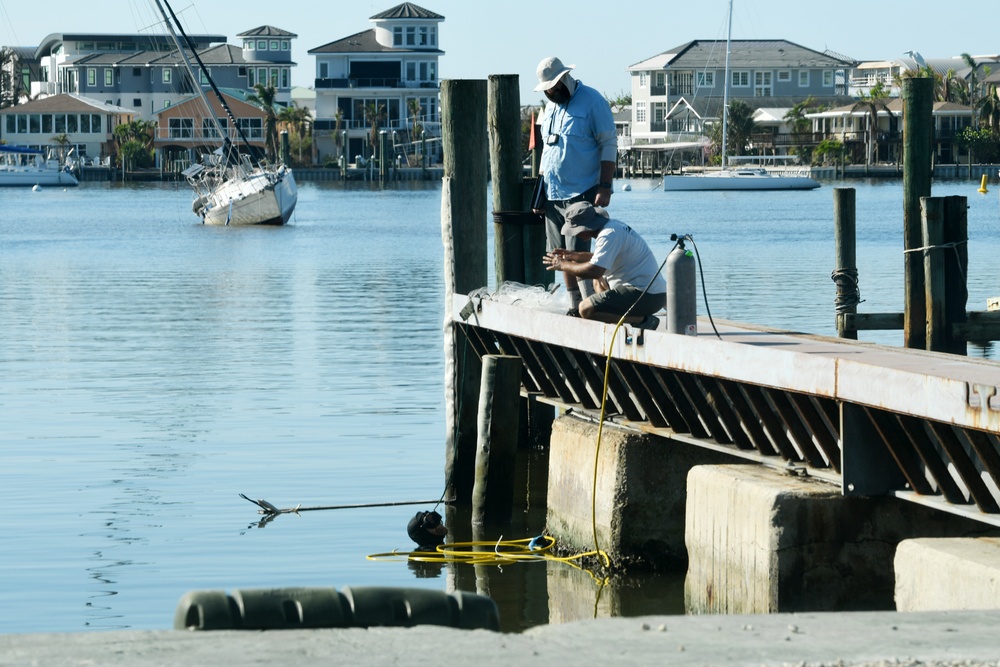 Crews Work to Check Safety of Pilings on Docks Damaged by Hurricane Ian