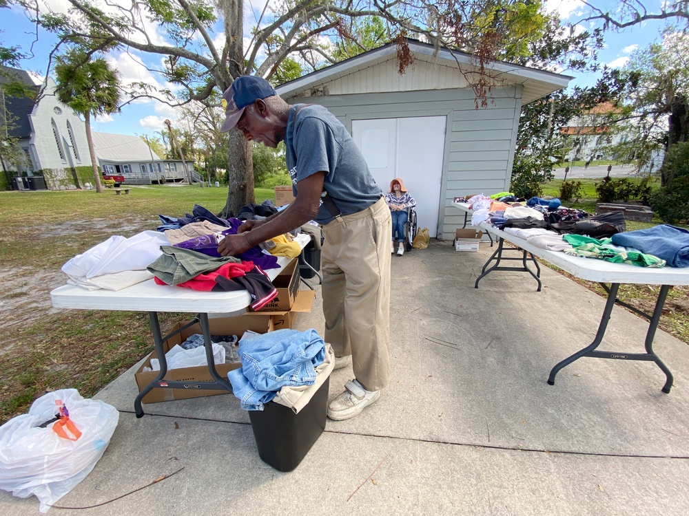 A Local Resident Looks Through Donated Items