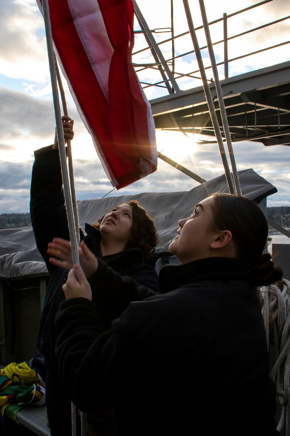 U.S. Navy Sailors Raise The Ensign