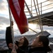 U.S. Navy Sailors Raise The Ensign