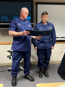 Capt. Darwin A. Jensen presents Chief Petty Officer Brian Wereda with the Coast Guard Commendation Medal