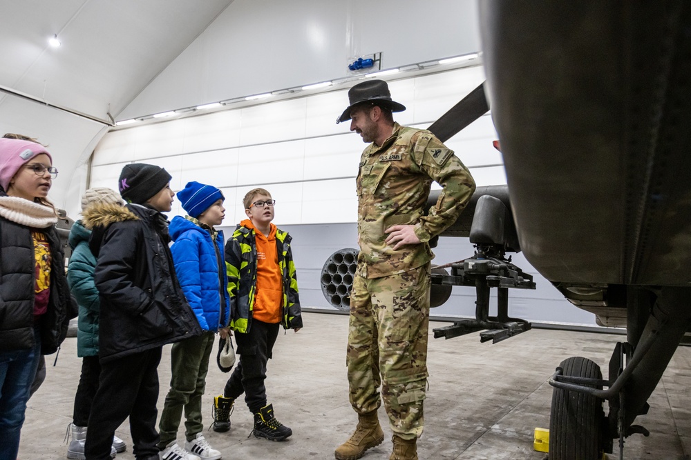 U.S. Army Soldier Teaches Polish Elementary schooler about AH-64 Apaches