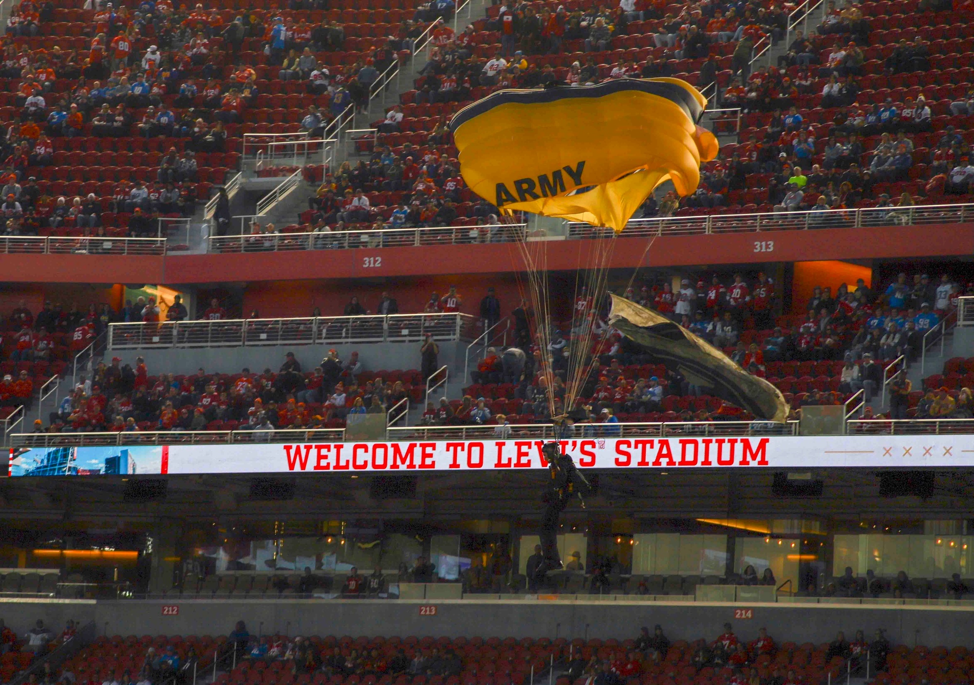 A member of the U.S. Army Golden Knights Parachute team performs a  demonstration prior to the San Francisco 49'ers Salute to Service game Nov.  13, 2022, at Levi's Stadium, Santa Clara, California.