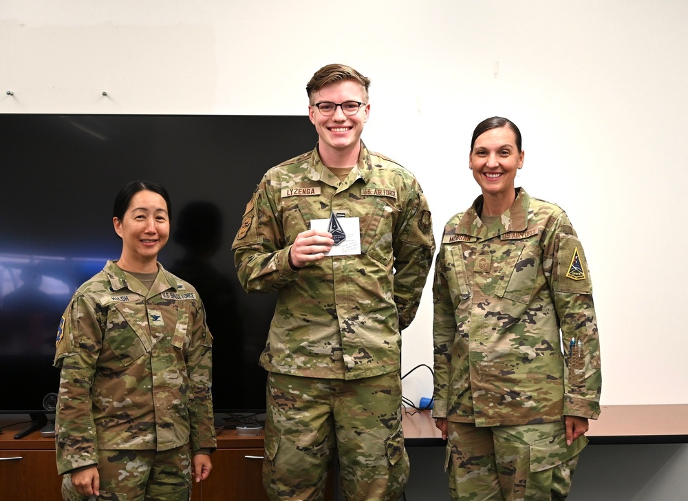 Cadet Lyzenga poses for a picture with SBD 3 commander after receiving his USSF patch