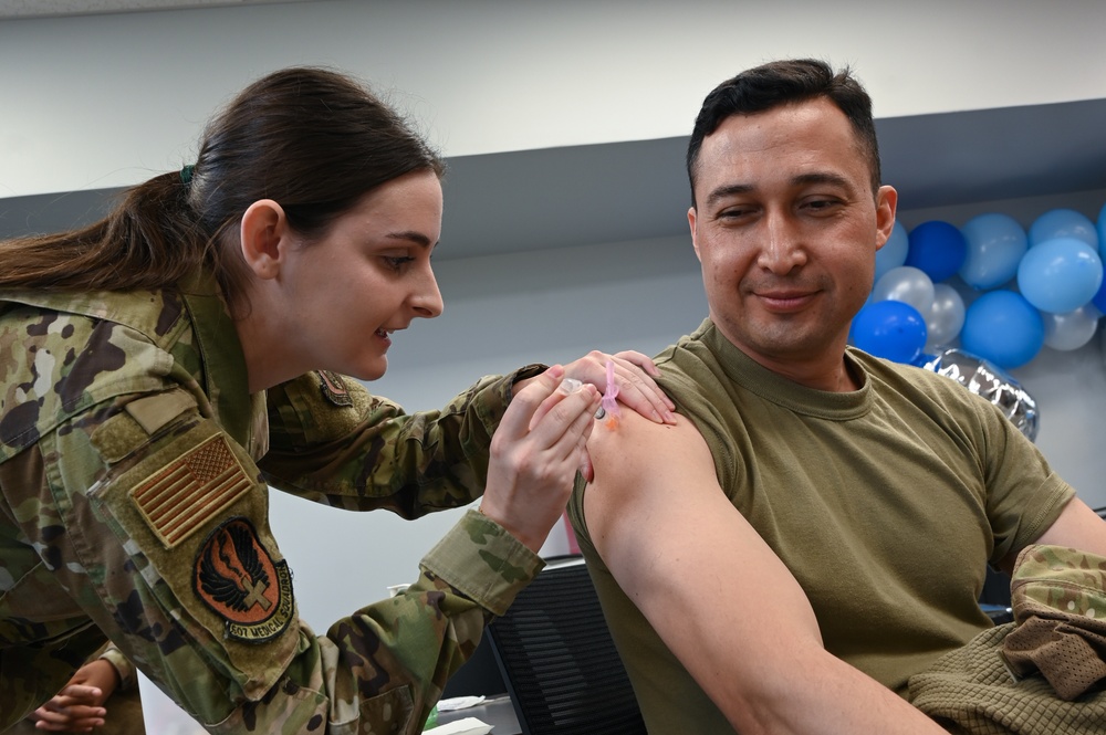 Medical technicians administer flu vaccine