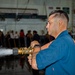 Sailor Sprays Down The Hangar Deck During a Sprinkler Test Aboard CVN 70