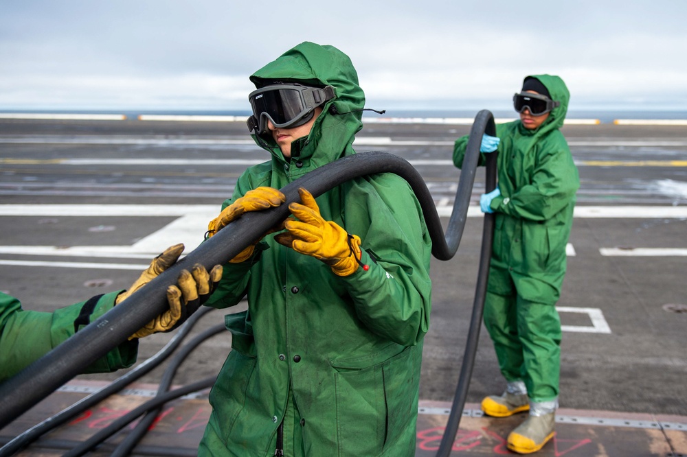 Sailor Participates in a Counter-Measure Wash-down Aboard CVN 70