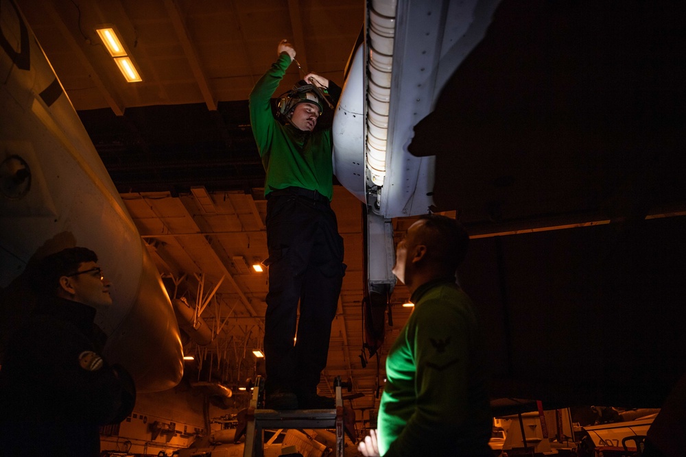 Sailors Perform Maintenance On A Super Hornet