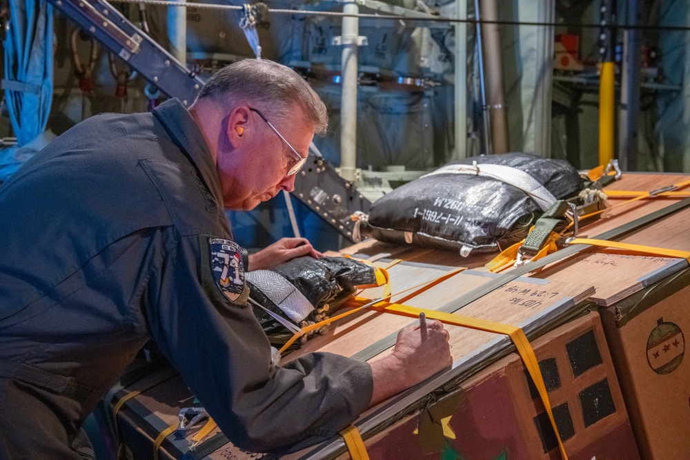 5th Air Force, United States Forces Japan, Alaskan Air Force and 11th Air Force command team drop bundles during Operation Christmas Drop 2022