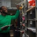 USS Ronald Reagan (CVN 76) Sailors work in post office