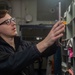 USS Ronald Reagan (CVN 76) Sailors work in post office