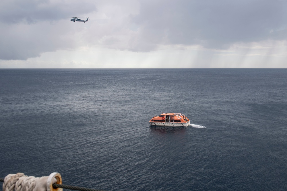 Civilian Mariners help patients onto the USNS Comfort