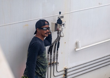 Civilian Mariners help patients onto the USNS Comfort