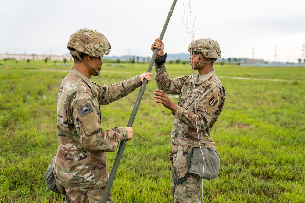 Soldiers conduct signal operations in a field environment