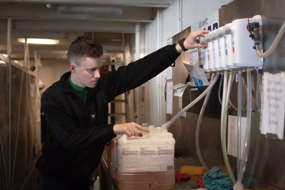 U.S. Navy Sailor Refills Cleaning Bottles