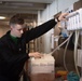 U.S. Navy Sailor Refills Cleaning Bottles