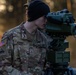 Pfc. Robbins lookin through a German viewfinder at the firing point of the call for fire mission