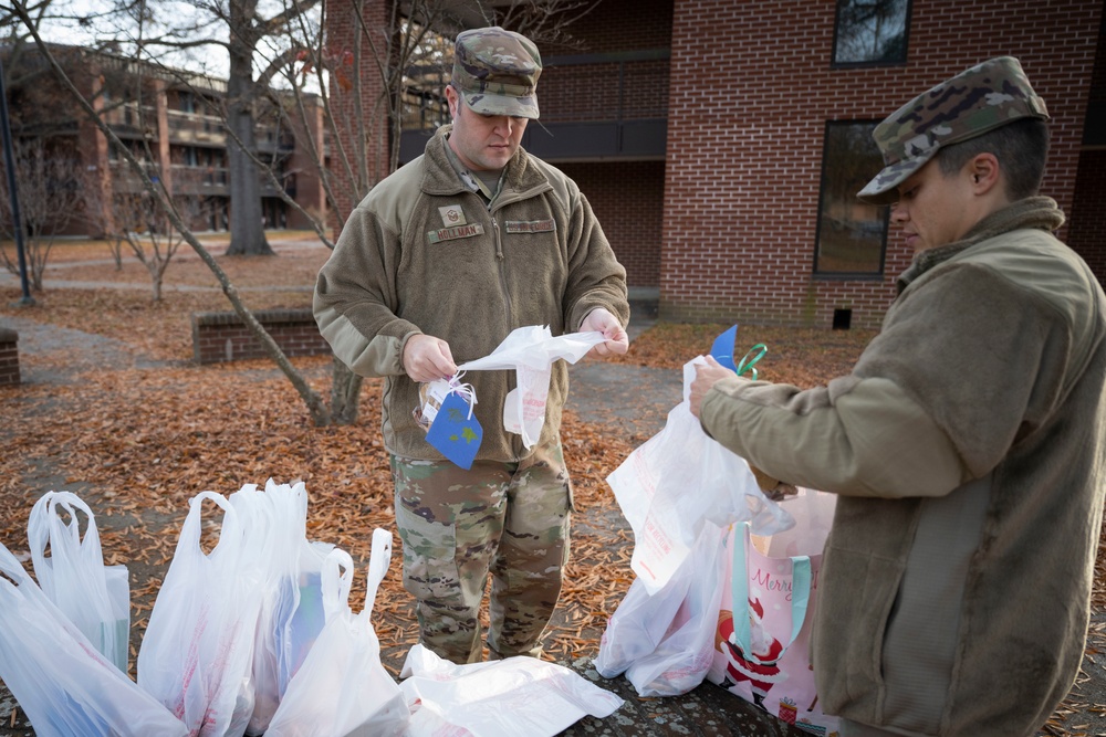 Team Seymour Spouses Club donates cookies to dorm Airmen