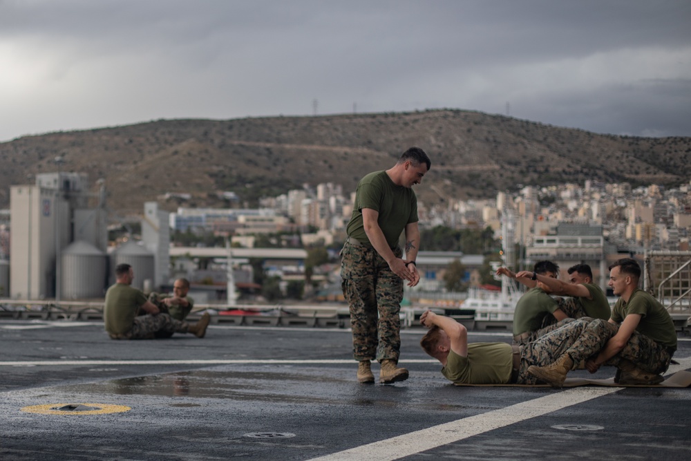 U.S. Marines with II MEF conduct Physical Training aboard USNS Trenton