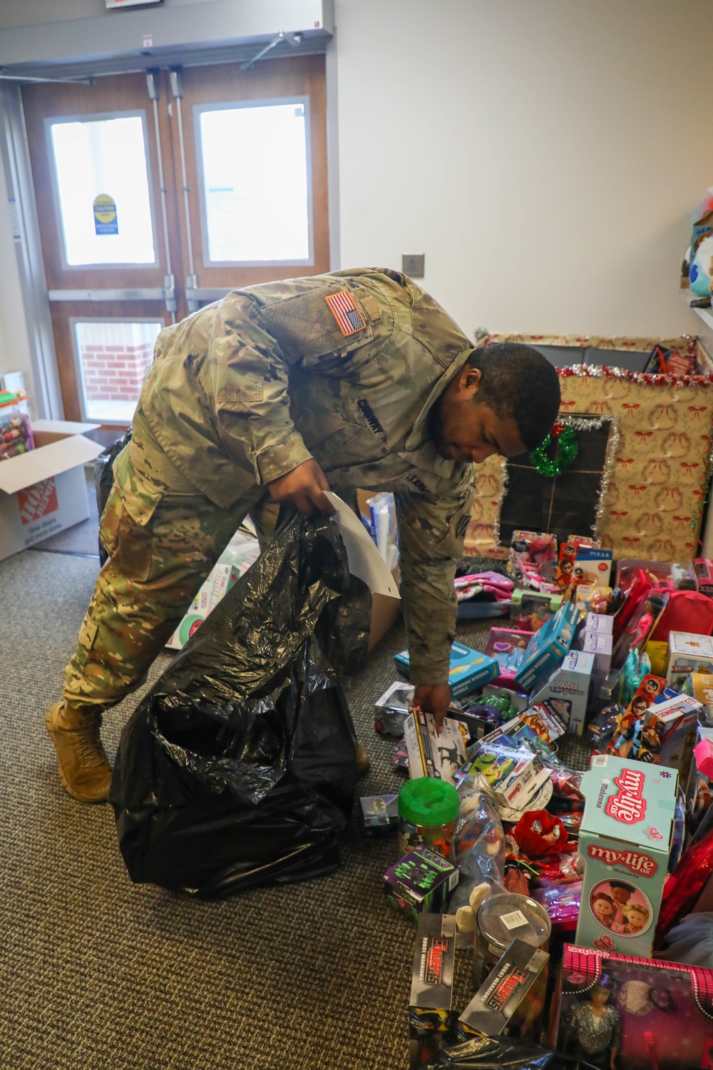 Soldiers from the 3rd Infantry Division help with the Army Community Service Toy Drive